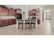 Large kitchen with dark cabinets, a central island with seating, and modern appliances at 11129 E Reginald Ave, Mesa, AZ 85212