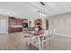 Spacious open-concept kitchen with stainless steel appliances and center island with countertop seating and brown cabinets at 11129 E Reginald Ave, Mesa, AZ 85212
