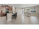 Spacious kitchen with dark cabinets, black appliances, a breakfast bar and adjacent dining area at 11129 E Reginald Ave, Mesa, AZ 85212