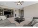 Cozy living room with a large entertainment center, gray sofas, and modern ceiling fan at 11129 E Reginald Ave, Mesa, AZ 85212