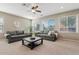 Bright living room with two gray sofas, large windows with blinds, and a decorative wall clock at 11129 E Reginald Ave, Mesa, AZ 85212