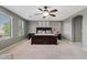 A spacious main bedroom with carpet, lots of windows, ceiling fan and neutral paint at 11129 E Reginald Ave, Mesa, AZ 85212