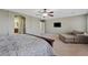 A main bedroom featuring carpet, sitting area, ceiling fan and ensuite bathroom entrance at 11129 E Reginald Ave, Mesa, AZ 85212