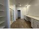 Bright bathroom featuring a glass-enclosed shower, double vanity, and wood-look tile flooring at 11796 N Vanero Ct, Maricopa, AZ 85139