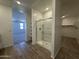 Bathroom featuring a glass-enclosed shower, storage shelving and warm wood-look flooring at 11796 N Vanero Ct, Maricopa, AZ 85139