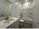 Bathroom features a tub/shower combo and sleek vanity with a quartz countertop at 11796 N Vanero Ct, Maricopa, AZ 85139