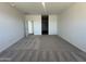 Neutral bedroom features neutral carpet and multiple doors at 11796 N Vanero Ct, Maricopa, AZ 85139