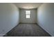 Empty carpeted bedroom with natural light from a single window at 11796 N Vanero Ct, Maricopa, AZ 85139