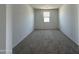 Neutral carpeted bedroom with a window letting in natural light at 11796 N Vanero Ct, Maricopa, AZ 85139
