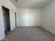 Cozy bedroom with neutral carpet and a closet with sliding doors at 11796 N Vanero Ct, Maricopa, AZ 85139