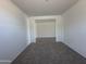 Spacious carpeted room showing an entrance with stylish flooring in an open-concept design at 11796 N Vanero Ct, Maricopa, AZ 85139