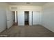 Bright bedroom with neutral carpet and closet featuring sliding doors at 11796 N Vanero Ct, Maricopa, AZ 85139