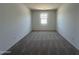 Empty bedroom with neutral carpet and a bright window at 11796 N Vanero Ct, Maricopa, AZ 85139