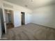 Bedroom with neutral carpet, open doorway, and closet with double doors at 11796 N Vanero Ct, Maricopa, AZ 85139