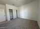 This carpeted bedroom features a closet with sliding doors at 11796 N Vanero Ct, Maricopa, AZ 85139