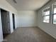 Bright bedroom with carpet flooring and spacious closet with bi-fold doors at 11796 N Vanero Ct, Maricopa, AZ 85139