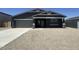 Charming single-story home featuring a modern exterior, two-car garage, and low-maintenance gravel landscaping at 11796 N Vanero Ct, Maricopa, AZ 85139