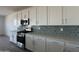 Well-equipped kitchen featuring stainless steel appliances, ample countertop space, and chic backsplash at 11796 N Vanero Ct, Maricopa, AZ 85139