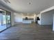 Open concept kitchen with island, stainless steel appliances, and sliding glass door to the backyard at 11796 N Vanero Ct, Maricopa, AZ 85139