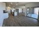 Open-concept kitchen boasts a large island, stainless steel appliances, and wood-look tile flooring at 11796 N Vanero Ct, Maricopa, AZ 85139