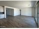 Bright, airy living room features wood-look tile flooring and sliding glass doors for indoor-outdoor living at 11796 N Vanero Ct, Maricopa, AZ 85139