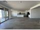 Expansive open-concept living space flows into kitchen, showcasing modern flooring and natural light at 11796 N Vanero Ct, Maricopa, AZ 85139