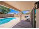Covered patio and pool are perfect for entertaining at 11805 W Sunnyside Dr, El Mirage, AZ 85335