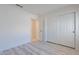 Bedroom with wood-look floors and large closets at 11805 W Sunnyside Dr, El Mirage, AZ 85335