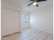 Bedroom with wood-look floors, window and closet at 11805 W Sunnyside Dr, El Mirage, AZ 85335