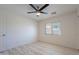 Spacious bedroom featuring ceiling fan, wood flooring and a large window at 11805 W Sunnyside Dr, El Mirage, AZ 85335