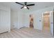 Primary bedroom featuring ceiling fan, wood flooring and closet at 11805 W Sunnyside Dr, El Mirage, AZ 85335
