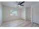 Light bedroom featuring ceiling fan, wood flooring and a window at 11805 W Sunnyside Dr, El Mirage, AZ 85335