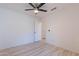 Bedroom features wood-look floors and door to hallway at 11805 W Sunnyside Dr, El Mirage, AZ 85335
