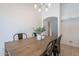Light-filled dining area featuring a wooden table with seating and modern chandelier lighting at 11805 W Sunnyside Dr, El Mirage, AZ 85335