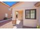 Inviting front entrance showcasing a covered porch, stone accents, and well-kept landscaping at 11805 W Sunnyside Dr, El Mirage, AZ 85335