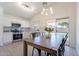 Eat-in kitchen features stainless steel appliances, white cabinetry, and a view of the pool at 11805 W Sunnyside Dr, El Mirage, AZ 85335