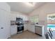 Kitchen with white cabinets, stainless appliances and access to a pool at 11805 W Sunnyside Dr, El Mirage, AZ 85335