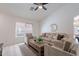 Bright living room featuring wood floors, neutral furnishings, and natural light at 11805 W Sunnyside Dr, El Mirage, AZ 85335