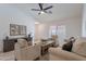 Bright living room boasts modern furnishings, wood flooring, and natural light at 11805 W Sunnyside Dr, El Mirage, AZ 85335