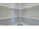 Walk-in pantry boasts ample white shelving for optimal kitchen storage at 11805 W Sunnyside Dr, El Mirage, AZ 85335