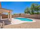 Backyard features sparkling pool and covered patio at 11805 W Sunnyside Dr, El Mirage, AZ 85335