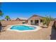 Backyard featuring a free form pool and low-maintenance desert landscaping, with an attached covered patio at 11805 W Sunnyside Dr, El Mirage, AZ 85335