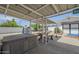 Spacious covered patio with picnic table, hot tub, cafe lights, and nice landscaping at 120 S Olive --, Mesa, AZ 85204