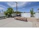 Spacious backyard featuring a large concrete area, seating, a covered patio, and white block privacy walls at 120 S Olive --, Mesa, AZ 85204