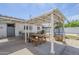 Backyard featuring picnic table, hot tub, cafe lights, a trampoline and partially covered concrete at 120 S Olive --, Mesa, AZ 85204
