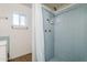 Bathroom featuring light blue tiles, a window, and a shower with a white curtain at 120 S Olive --, Mesa, AZ 85204