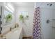 Bathroom features plants, strawberry-themed shower curtain, vanity, and white brick walls at 120 S Olive --, Mesa, AZ 85204