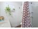 Bright bathroom features a toilet, shower stall, white brick, plants, and a vanity at 120 S Olive --, Mesa, AZ 85204