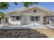Charming single story home featuring a covered front porch with decorative railings and a star accent at 120 S Olive --, Mesa, AZ 85204