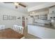 Open concept kitchen featuring a breakfast nook, white cabinetry and granite countertops, flowing into an adjoining room at 120 S Olive --, Mesa, AZ 85204